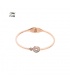 Roségoudkleurige spang armband met uitgesneden hart en een klein steentje
