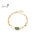 Armband goudkleurig met marmerlook groene steen en hartje