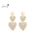 Oorbellen met dubbele harten en beige steentjes